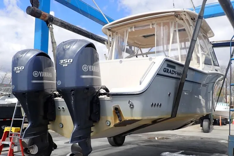 Slide: The Image of 2016 Grady-White Freedom 335 boat with twin Yamaha 350 V8 engines on a lift. - 8