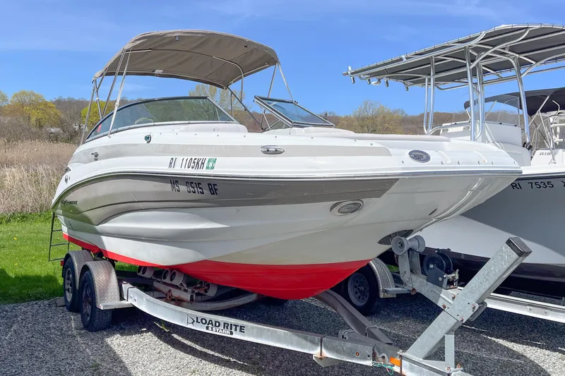 The Image of 2015 Crownline Eclipse E2 XS boat on trailer, parked outdoors. - 0