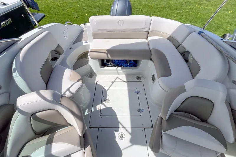 Slide: The Image of 2015 Crownline Eclipse E2 XS boat interior with spacious seating and storage compartments. - 2