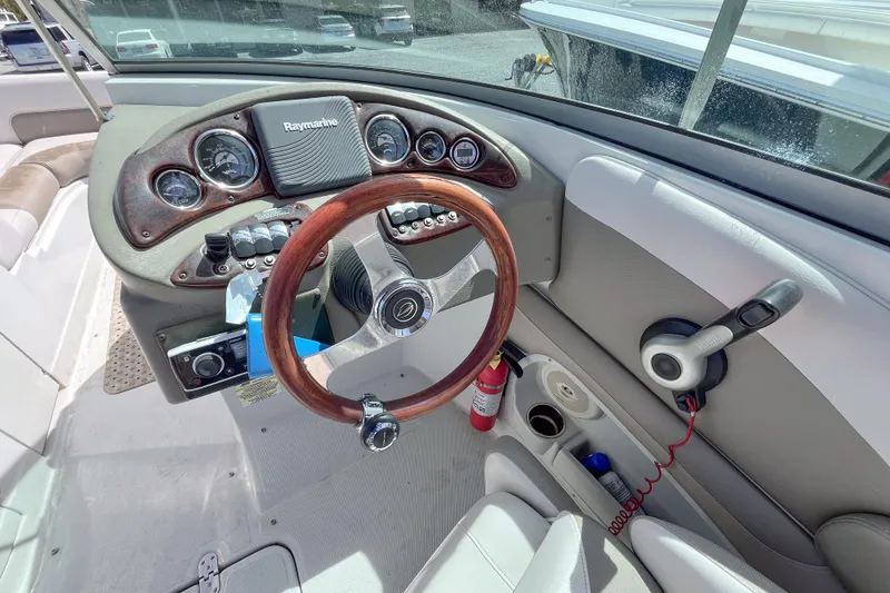 Slide: The Image of 2015 Crownline Eclipse E2 XS boat dashboard with steering wheel and controls. - 3