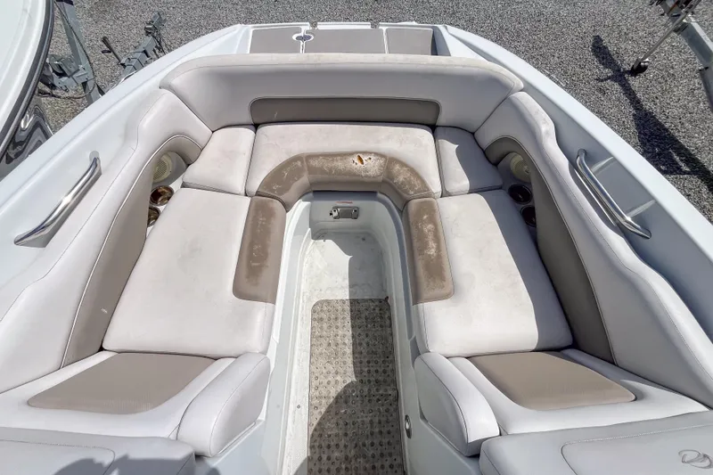 Slide: The Image of 2015 Crownline Eclipse E2 XS boat interior with cushioned seating and cup holders. - 4