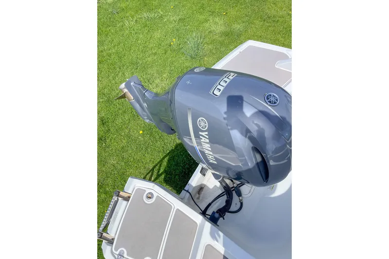 Slide: The Image of 2015 Crownline Eclipse E2 XS with Yamaha outboard motor on grassy background. - 7