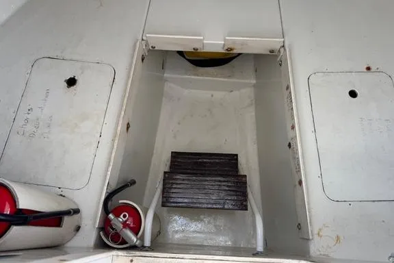 Slide: The Image of Interior of a 1996 Island Hopper Forward Cabin Dive Boat with fire extinguishers and wooden steps. - 10