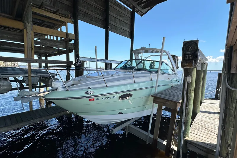 Slide: The Image of 2014 Monterey 260 Sport Yacht docked in a covered marina, sunny day. - 10