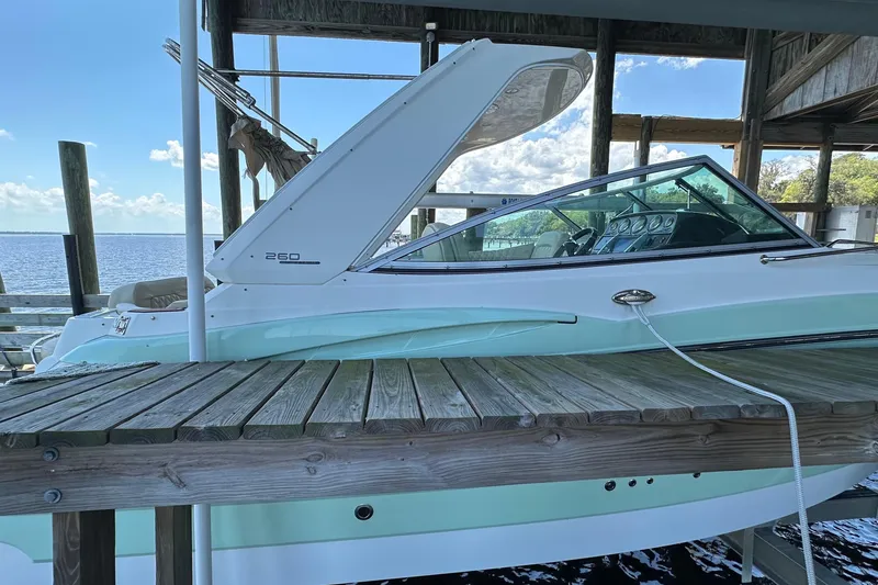 Slide: The Image of 2014 Monterey 260 Sport Yacht docked, showcasing sleek design and modern features. - 12