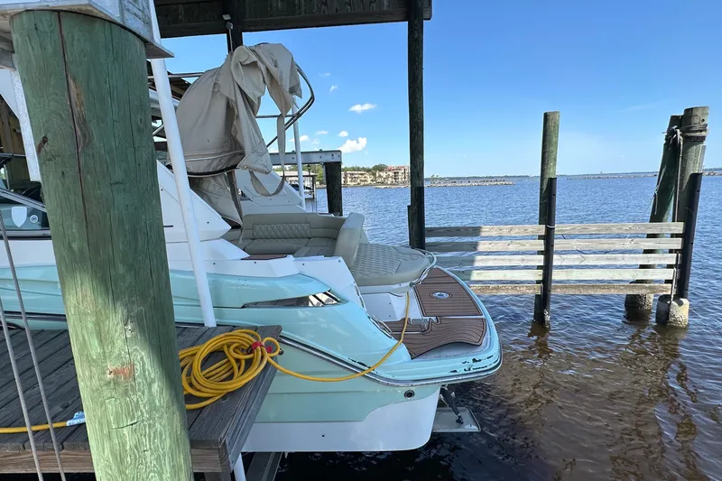 Slide: The Image of 2014 Monterey 260 Sport Yacht docked by the water, featuring a sleek design and vibrant exterior. - 15