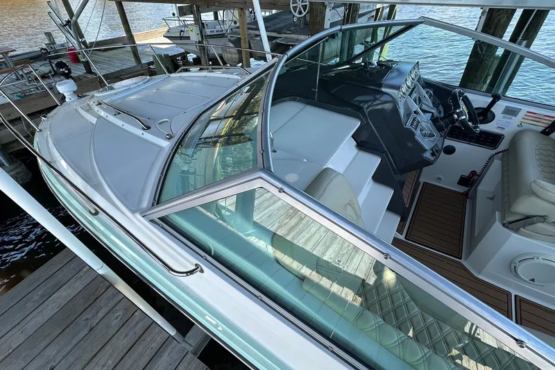 Slide: The Image of 2014 Monterey 260 Sport Yacht docked, showcasing sleek design and spacious cockpit. - 16