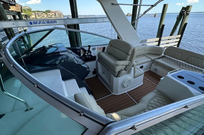 Slide: The Image of 2014 Monterey 260 Sport Yacht interior with luxurious seating and scenic waterfront view. - 18