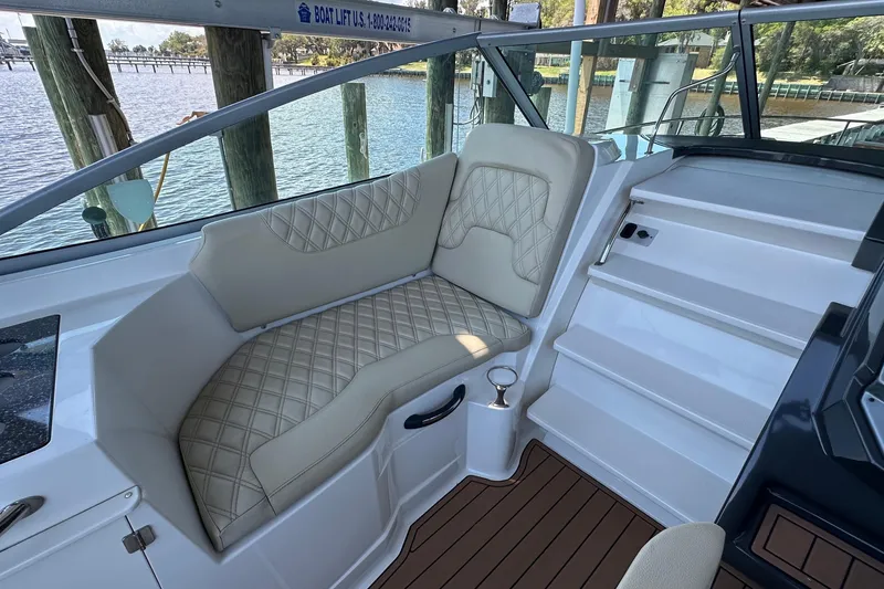 Slide: The Image of Luxurious seating on a 2014 Monterey 260 Sport Yacht, featuring elegant diamond-pattern upholstery. - 20