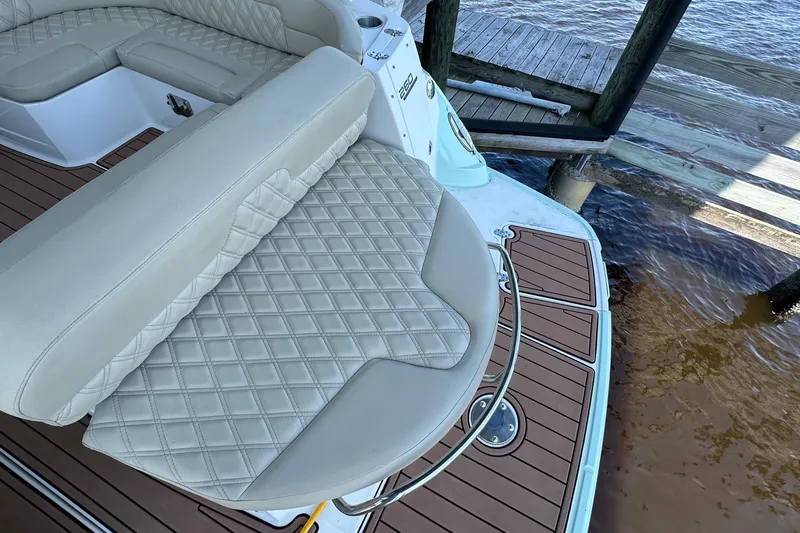 Slide: The Image of Luxurious seating on 2014 Monterey 260 Sport Yacht, docked by the water. - 23