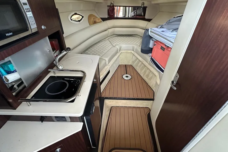 Slide: The Image of Interior of 2014 Monterey 260 Sport Yacht with kitchenette and cozy seating area. - 25