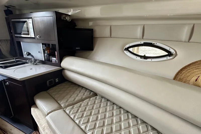 Slide: The Image of Interior of 2014 Monterey 260 Sport Yacht with kitchenette and seating area. - 27