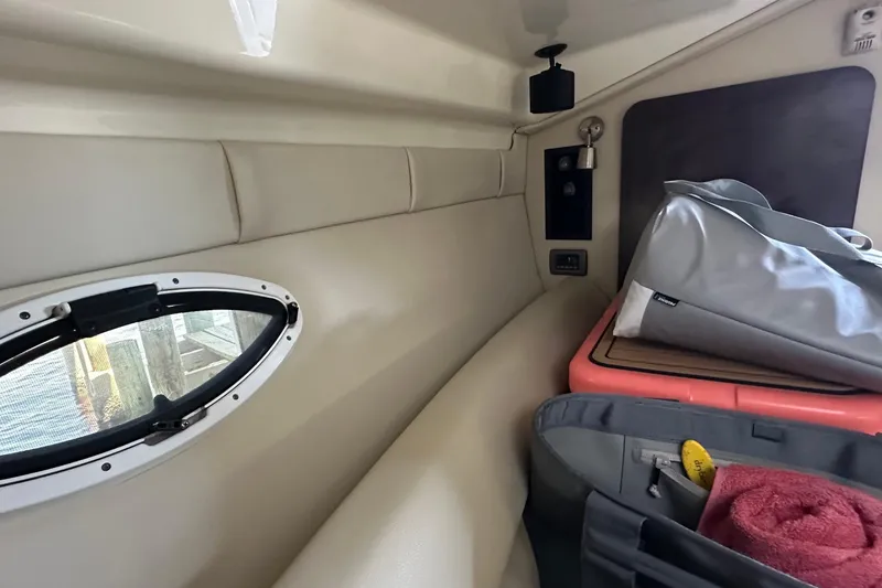 Slide: The Image of Interior cabin of 2014 Monterey 260 Sport Yacht with storage and porthole. - 28