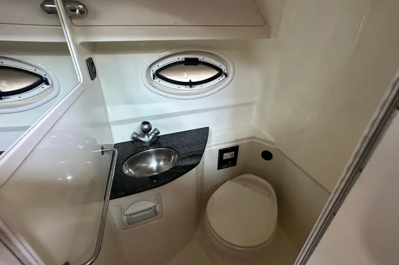 Slide: The Image of Bathroom interior of 2014 Monterey 260 Sport Yacht with sink and toilet. - 30