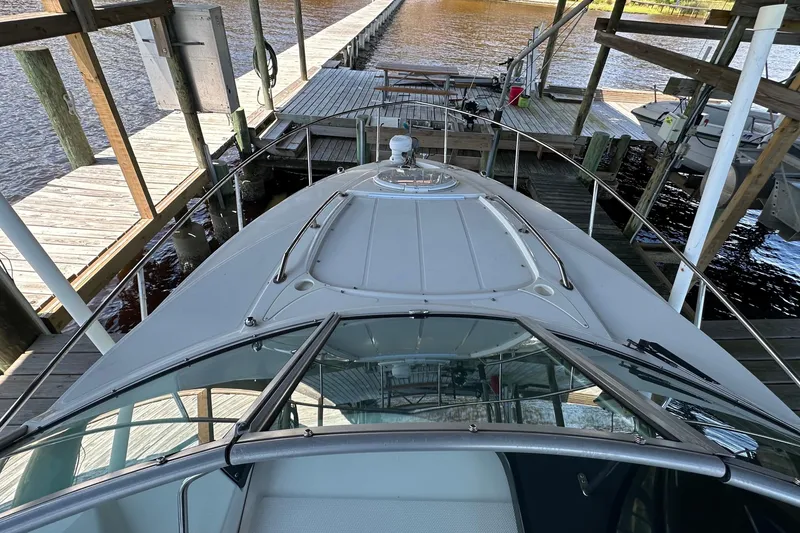 Slide: The Image of 2014 Monterey 260 Sport Yacht docked at a marina, viewed from the bow. - 31