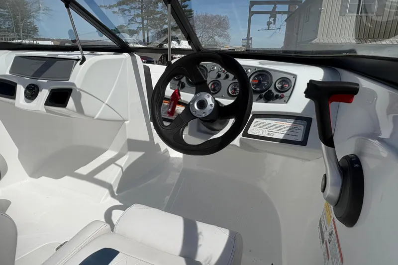 Slide: The Image of Interior view of 2022 Tahoe 185 S boat dashboard and steering wheel. - 5