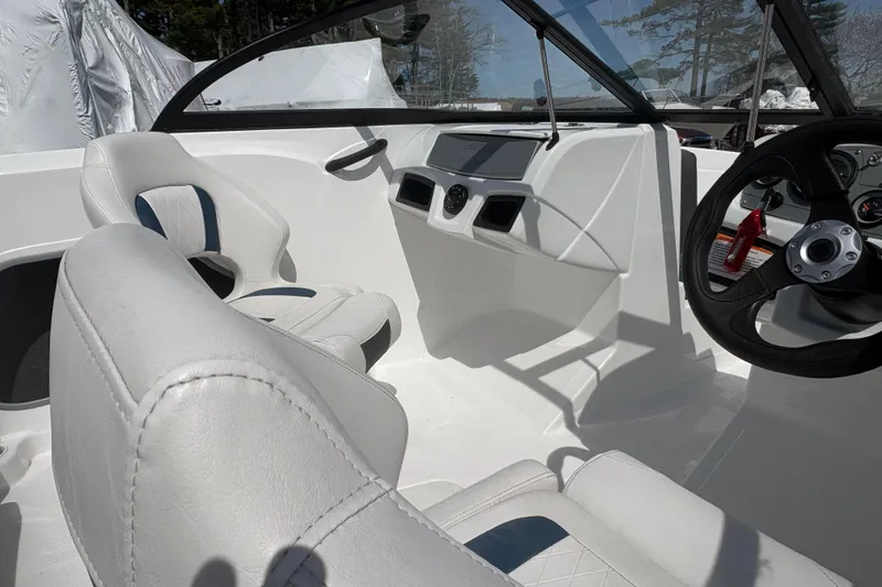 Slide: The Image of Interior of a 2022 Tahoe 185 S boat, featuring sleek white seating and modern dashboard. - 6