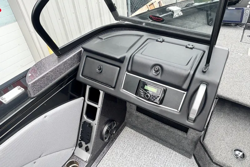 Slide: The Image of Interior of 2023 Ranger VX1888 WT boat, featuring dashboard and control panel. - 11