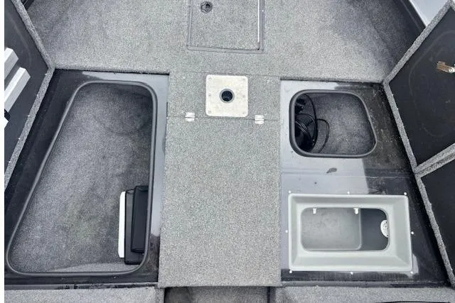 Slide: The Image of 2023 Ranger VX1888 WT boat interior with storage compartments and carpeted flooring. - 6