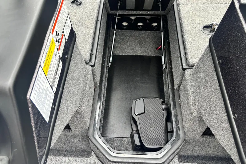 Slide: The Image of Interior view of 2023 Ranger VX1888 WT boat, featuring storage compartment and pedal control. - 7