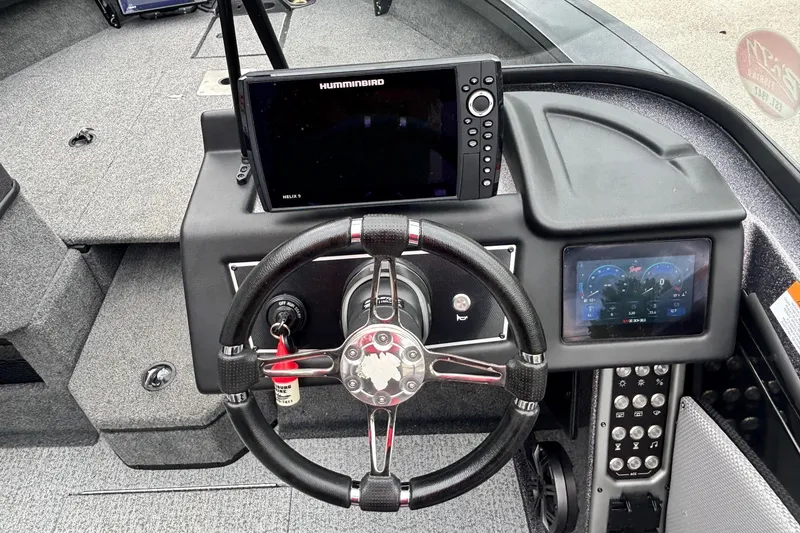 Slide: The Image of 2023 Ranger VX1888 WT boat dashboard with steering wheel and electronic displays. - 9