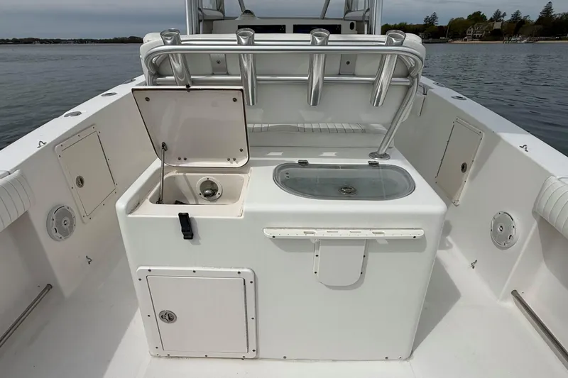 Slide: The Image of 2007 Sea Hunt Gamefish 29 boat interior with open storage compartments and rod holders. - 11