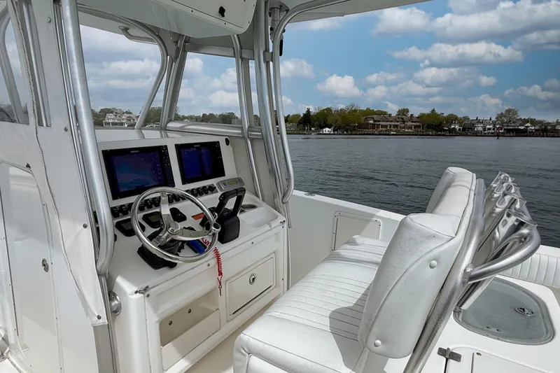 Slide: The Image of 2007 Sea Hunt Gamefish 29 boat cockpit with dual screens and steering wheel. - 12