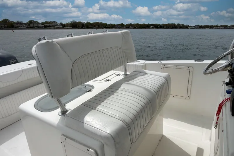 Slide: The Image of 2007 Sea Hunt Gamefish 29 boat interior with white seating, steering wheel, and water view. - 16