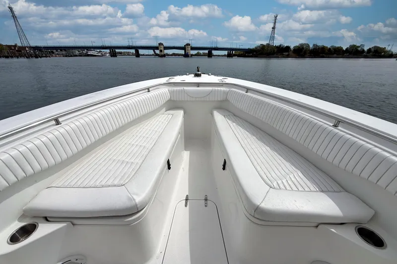 Slide: The Image of 2007 Sea Hunt Gamefish 29 boat interior with white seating, calm water, and bridge view. - 18
