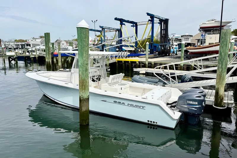 Slide: The Image of 2007 Sea Hunt Gamefish 29 boat docked at a marina with Yamaha engines. - 2