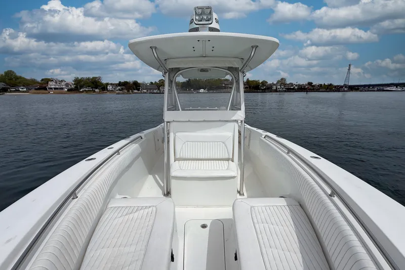 Slide: The Image of 2007 Sea Hunt Gamefish 29 boat on calm water under a cloudy sky. - 20