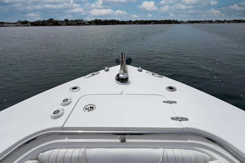 Slide: The Image of Bow view of 2007 Sea Hunt Gamefish 29 on calm water under cloudy sky. - 21