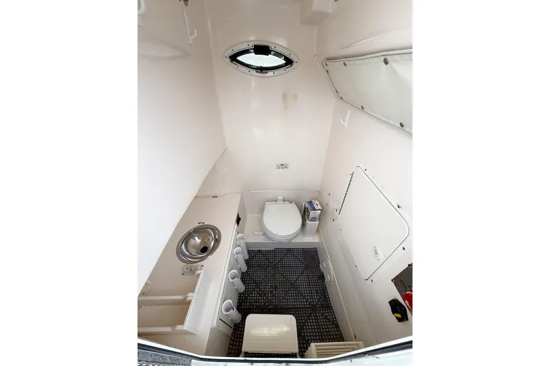 Slide: The Image of Interior of 2007 Sea Hunt Gamefish 29 boat, featuring compact bathroom amenities. - 22