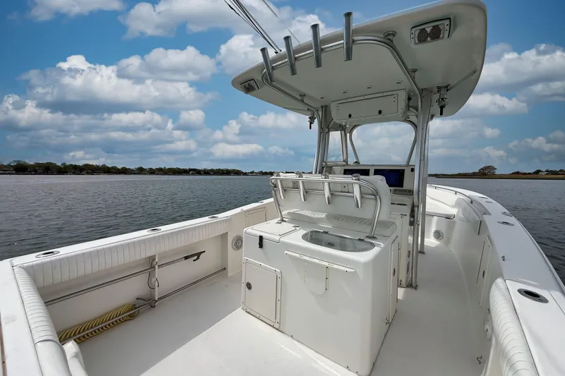 Slide: The Image of 2007 Sea Hunt Gamefish 29 boat on calm water under a cloudy sky. - 3