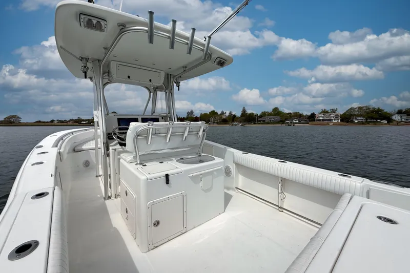 Slide: The Image of 2007 Sea Hunt Gamefish 29 boat on calm water under a partly cloudy sky. - 5