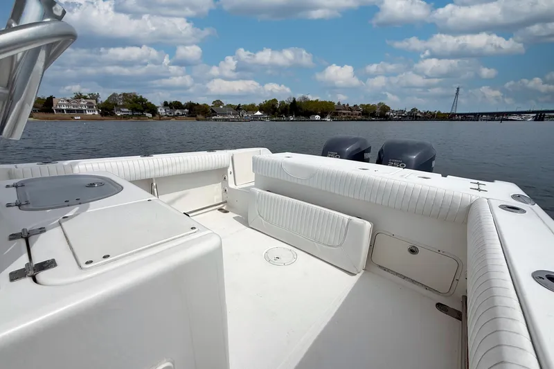 Slide: The Image of 2007 Sea Hunt Gamefish 29 boat interior with dual Yamaha engines on a calm lake. - 6
