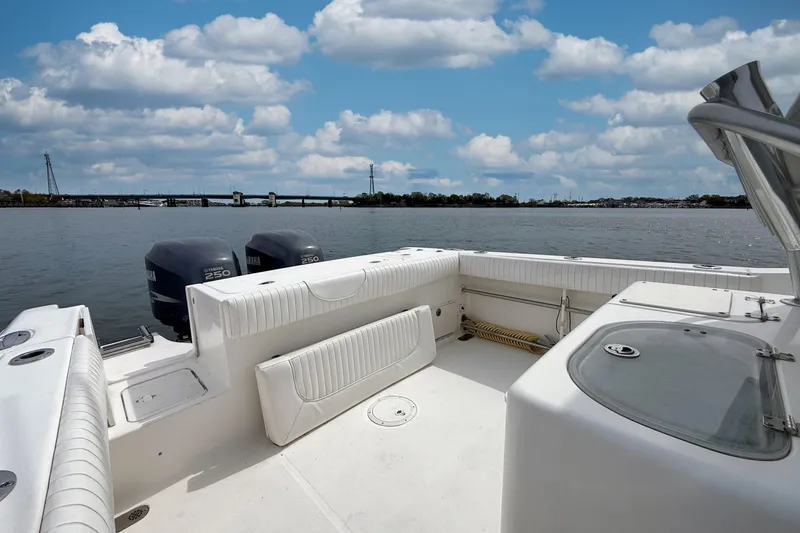 Slide: The Image of 2007 Sea Hunt Gamefish 29 boat with dual Yamaha 250 engines on a calm waterway. - 8