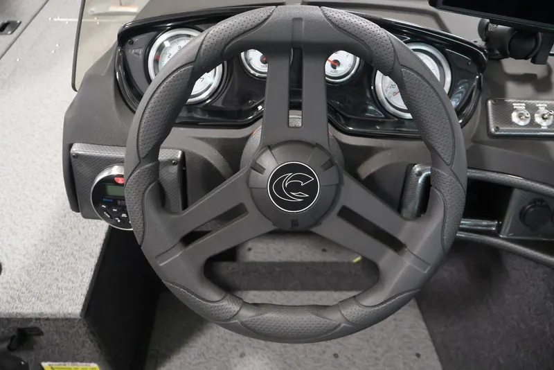 Slide: The Image of Steering wheel of 2026 Crestliner 1750 Fish Hawk SC boat, featuring modern dashboard controls. - 30
