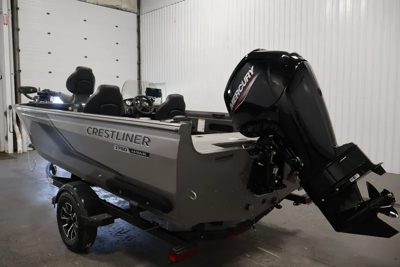 Slide: The Image of 2026 Crestliner 1750 Fish Hawk SC boat with Mercury outboard motor in a garage. - 12