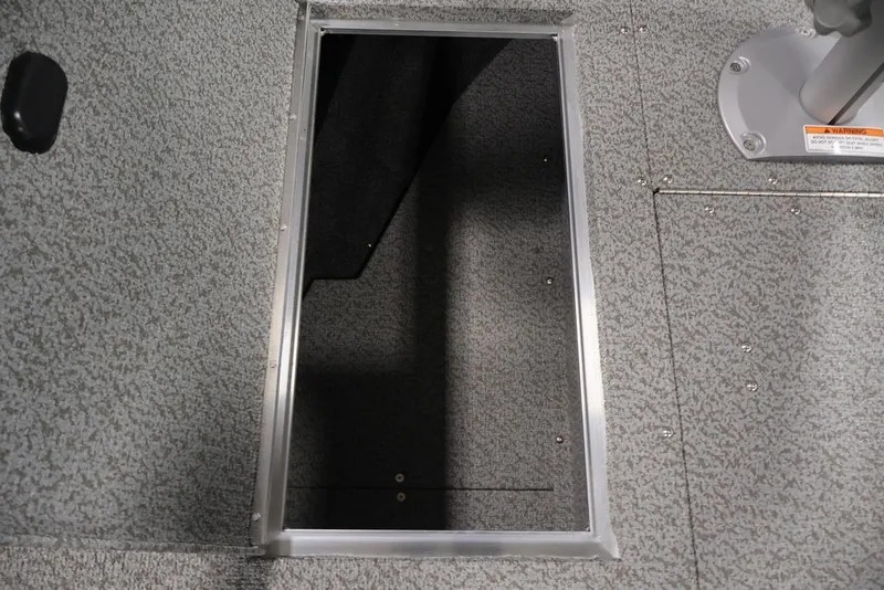 Slide: The Image of 2026 Crestliner 1750 Fish Hawk SC boat storage compartment with textured flooring. - 39