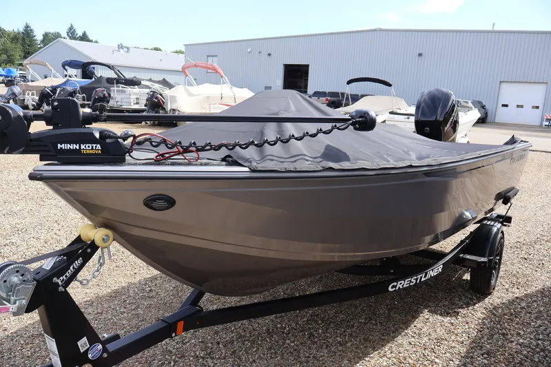 Slide: The Image of 2026 Crestliner 1750 Fish Hawk SC boat with Minn Kota Terrova motor, parked outdoors. - 45