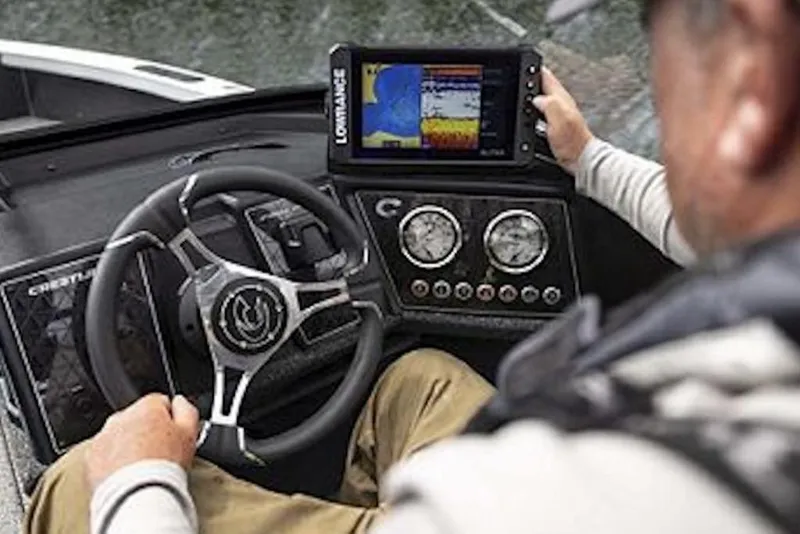 Slide: The Image of 2026 Crestliner 1750 Fish Hawk Side Console dashboard with steering wheel and navigation display. - 6