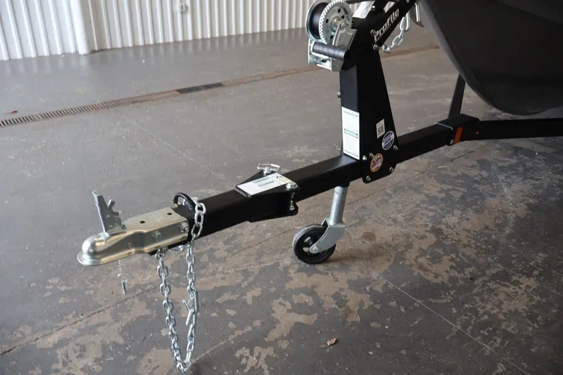 Slide: The Image of Trailer hitch of 2026 Crestliner 1750 Fish Hawk SC, featuring safety chains and wheel. - 25