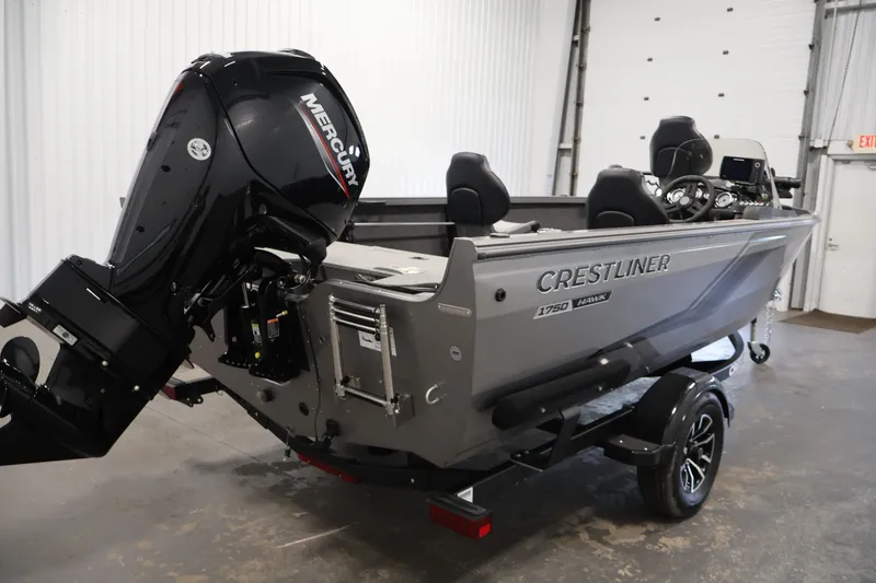 Slide: The Image of 2026 Crestliner 1750 Fish Hawk SC boat with Mercury outboard motor in a garage. - 11