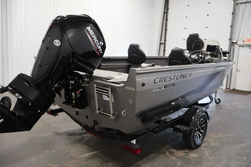Slide: The Image of 2026 Crestliner 1750 Fish Hawk SC boat with Mercury outboard motor in a garage. - 14