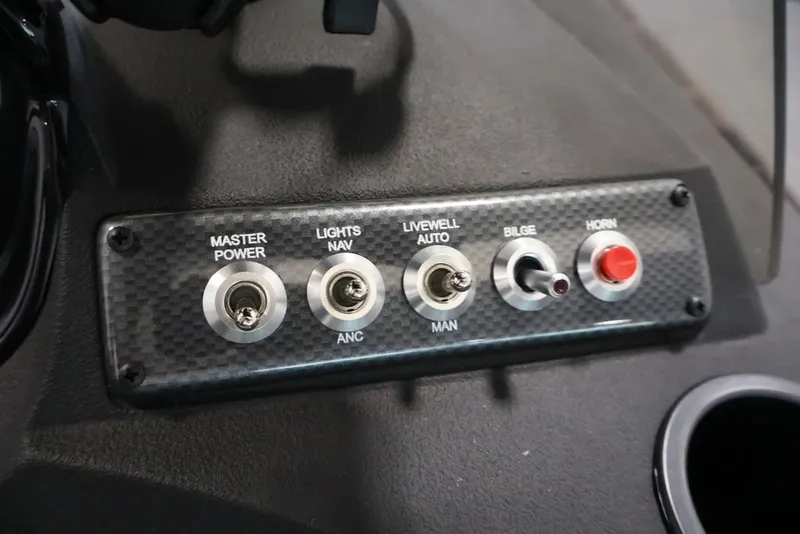 Slide: The Image of Control panel of 2026 Crestliner 1750 Fish Hawk SC boat with switches for power, lights, and horn. - 27