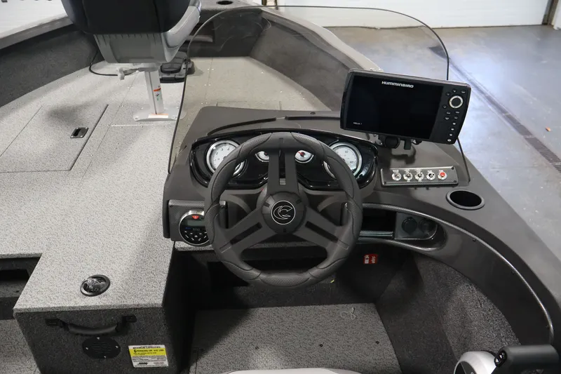 Slide: The Image of 2026 Crestliner 1750 Fish Hawk SC boat dashboard with steering wheel and navigation system. - 26