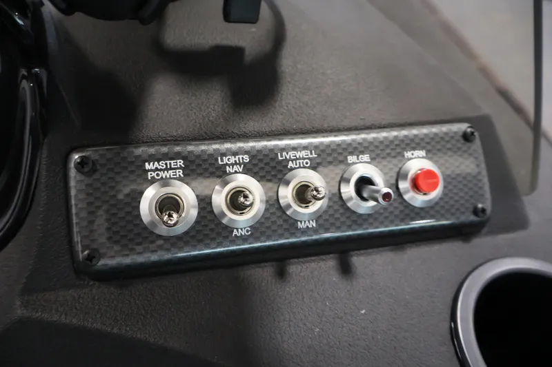 Slide: The Image of Control panel of 2026 Crestliner 1750 Fish Hawk SC boat with switches for power, lights, and horn. - 30