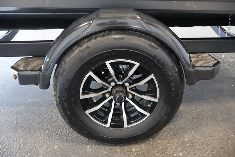 Slide: The Image of Trailer wheel of 2026 Crestliner 1750 Fish Hawk SC, featuring sleek black and silver design. - 36