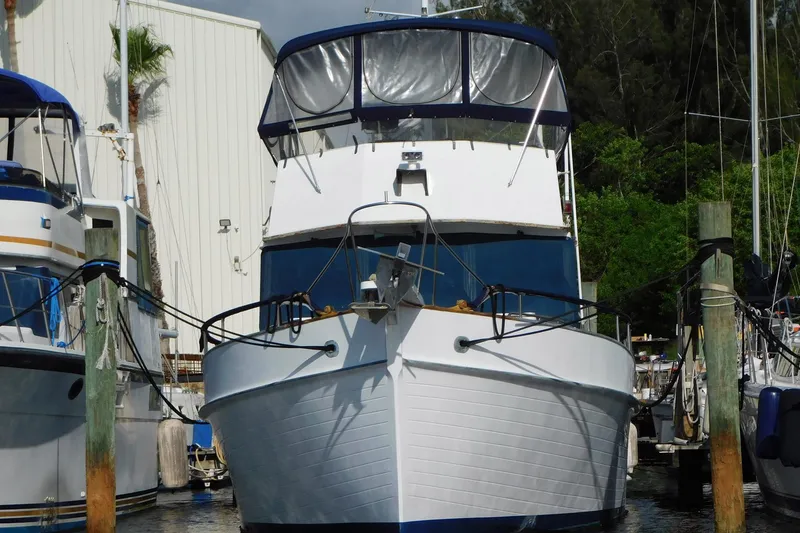 Slide: The Image of 1986 Grand Banks 46 Classic yacht docked at marina, front view. - 1